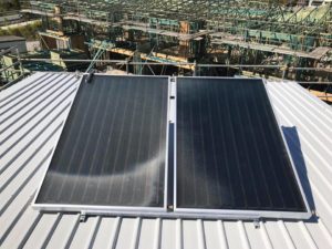 Solar hot water panels mounted on a metal roof on Bribie Island, forming part of an energy-efficient hot water system